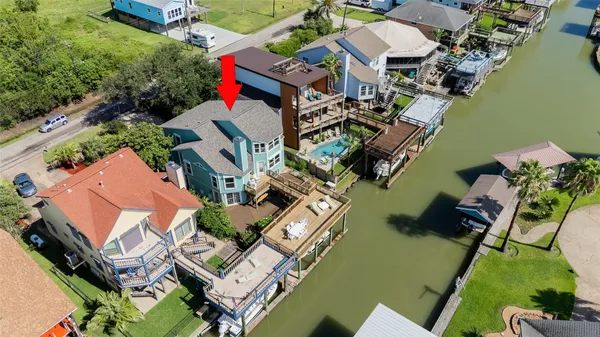 an aerial view of multiple houses with yard