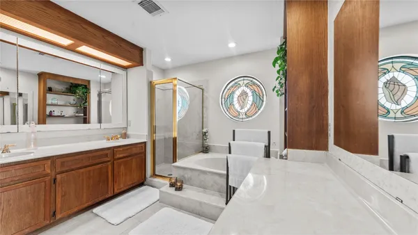 an empty room with windows and ceiling fan