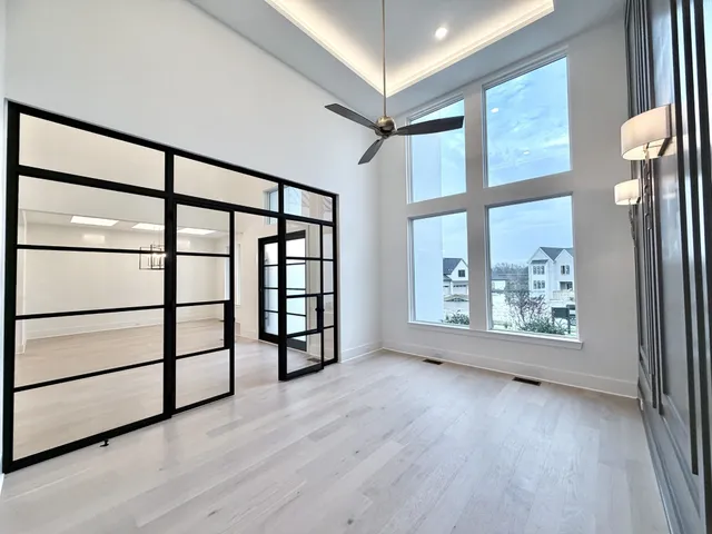a room with kitchen island a sink and wooden floor