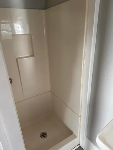 a bathroom with a glass shower door