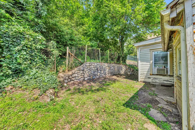 a view of a backyard with a tree