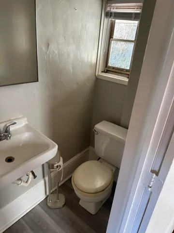 a white toilet sitting next to a bathroom sink