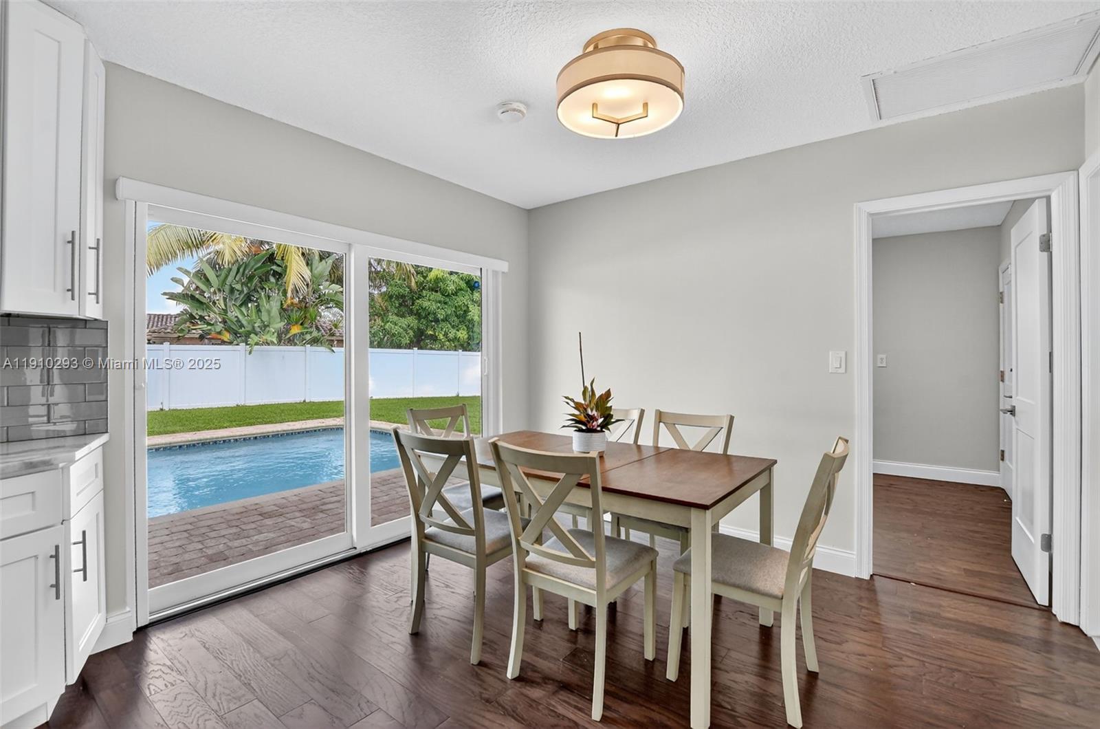 5660 Golfway Drive Boca Raton, FL 33433 - Photo 16 of 41 a view of a dining room with furniture window and wooden floor