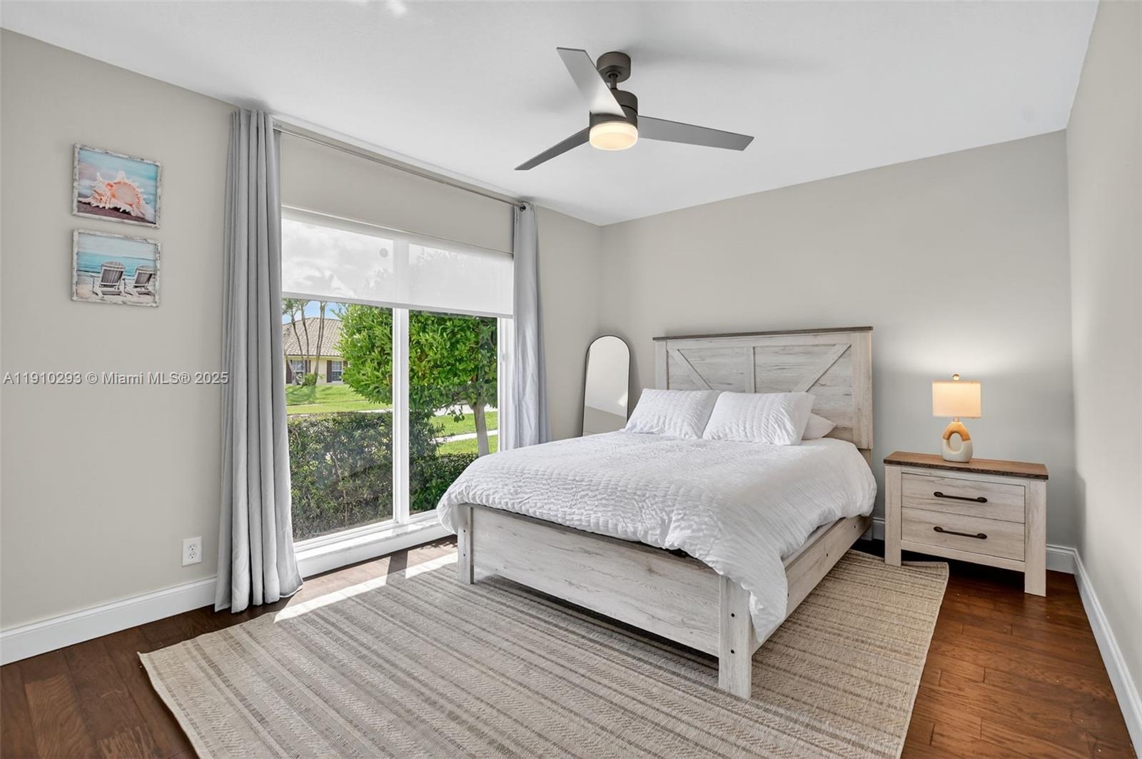 5660 Golfway Drive Boca Raton, FL 33433 - Photo 19 of 41 a bedroom with a bed and a large window