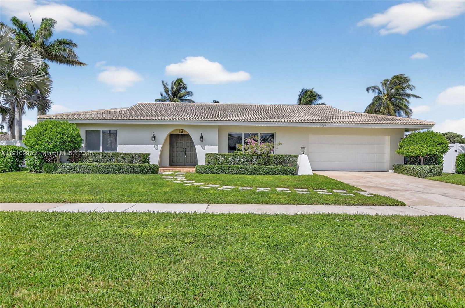 5660 Golfway Drive Boca Raton, FL 33433 - Photo 2 of 41 a front view of a house with a yard