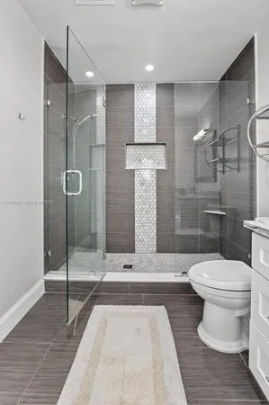 a bathroom with a toilet and a shower