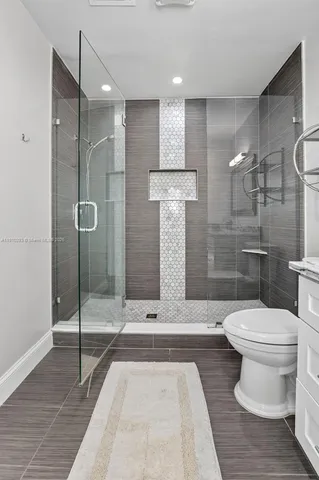 a bathroom with a toilet and a shower