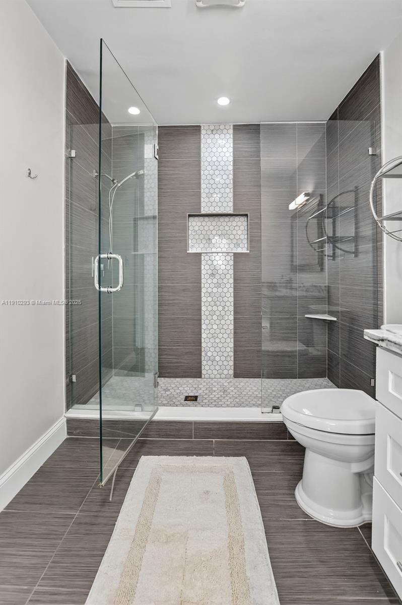 5660 Golfway Drive Boca Raton, FL 33433 - Photo 27 of 41 a bathroom with a toilet and a shower