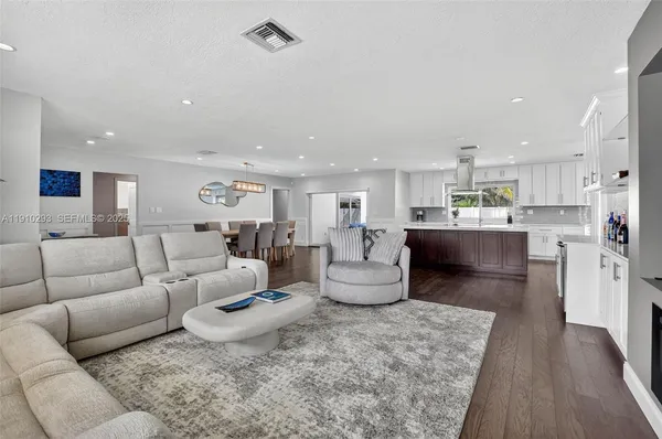 a living room with furniture and a kitchen view