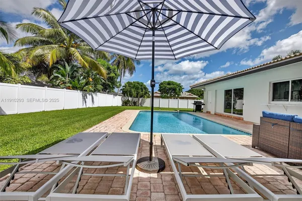 a view of a backyard with sitting area