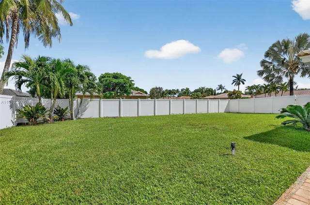 a view of yard with swimming pool and outdoor seating