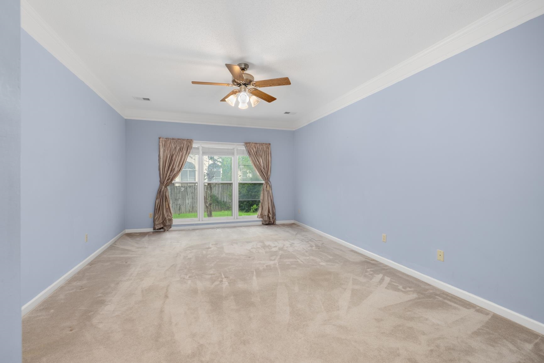 9015 Raspberry Lane Cordova, TN 38016 - Photo 22 of 40 Carpeted spare room featuring ceiling fan and ornamental molding