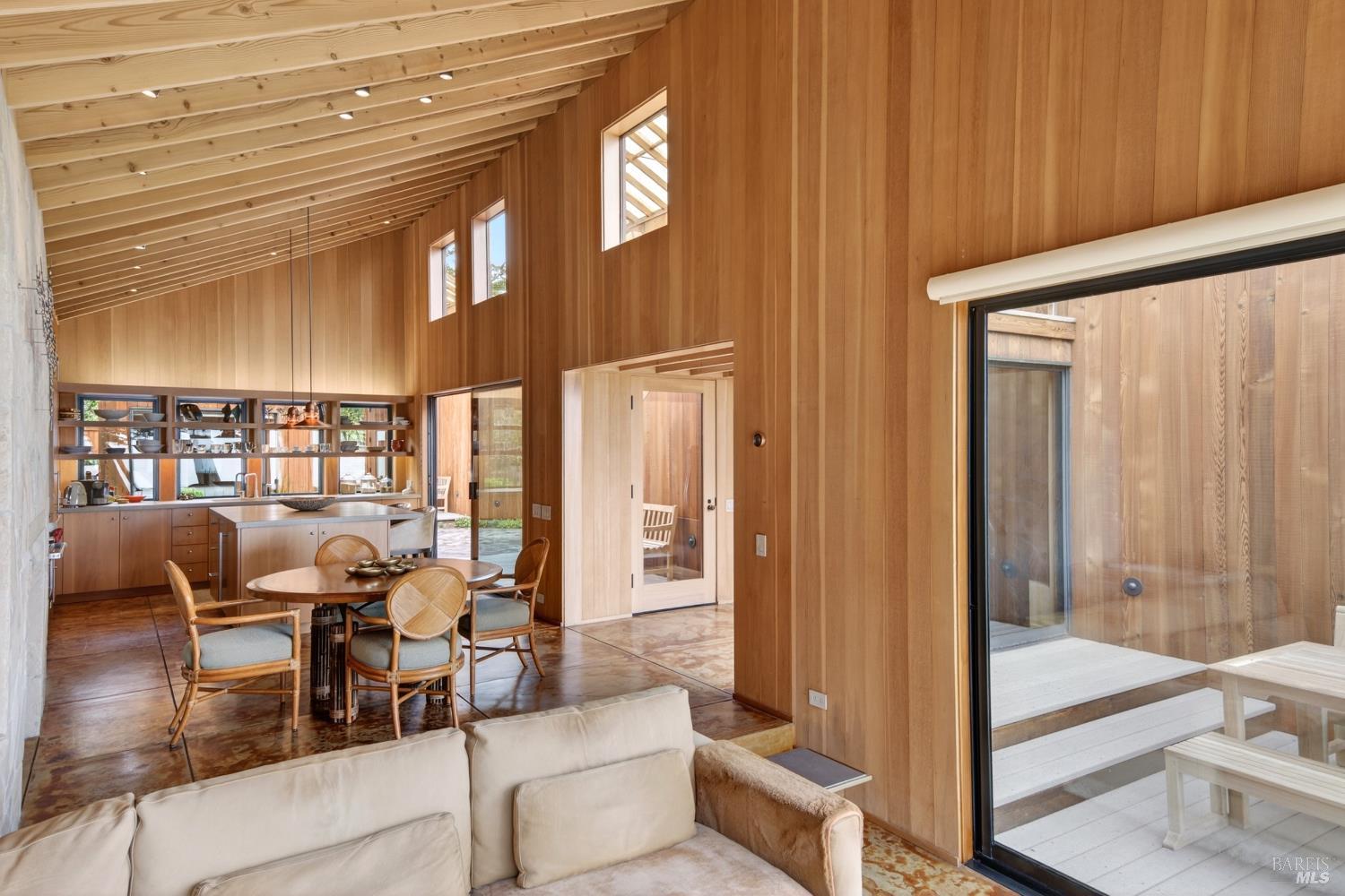233 Solstice The Sea Ranch, CA 95497 - Photo 12 of 90 Living/dining room/kitchen with glass sliding door to courtyard