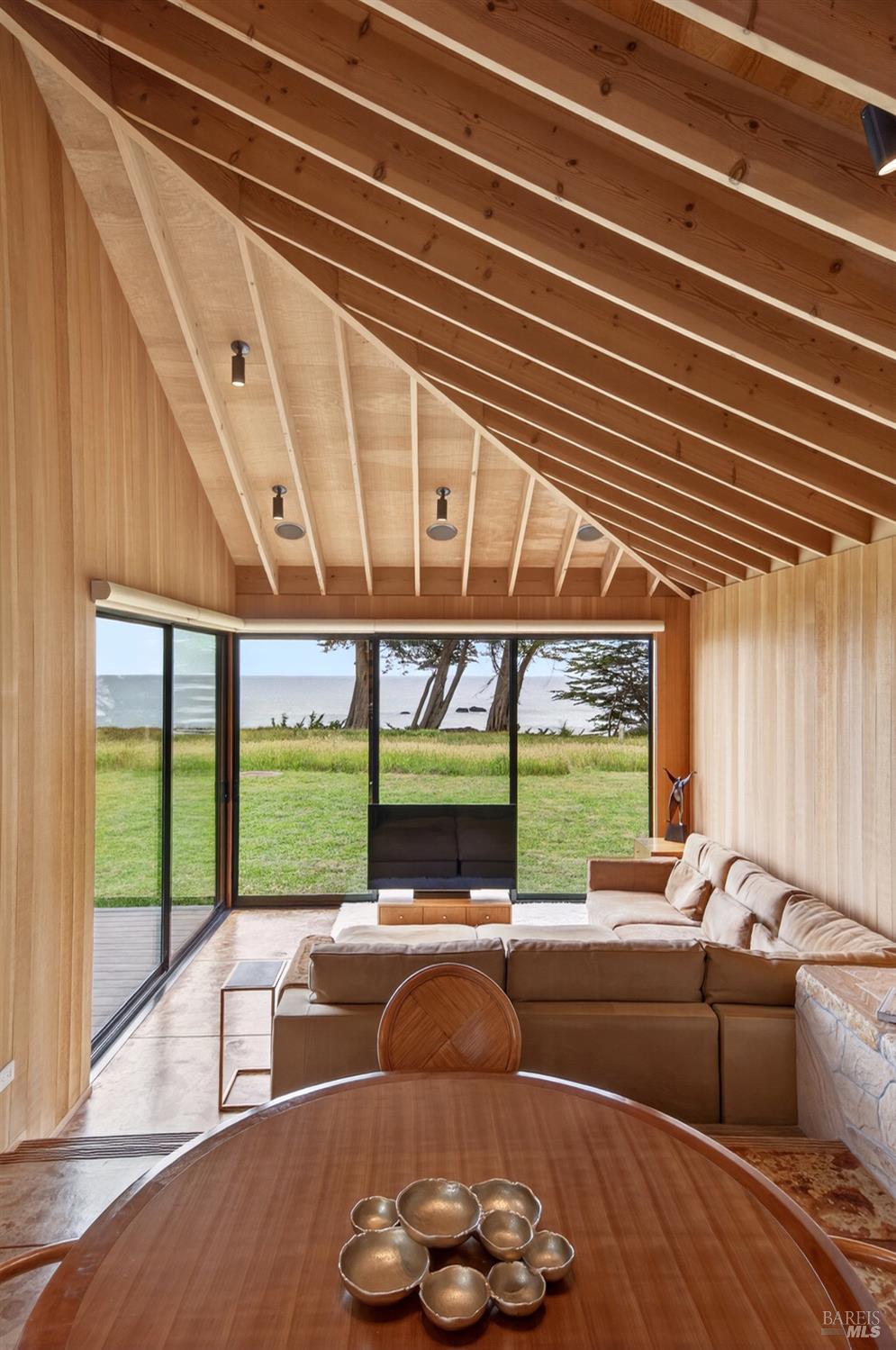 233 Solstice The Sea Ranch, CA 95497 - Photo 17 of 90 View from dining room into living room showing wood walls and open beam ceiling