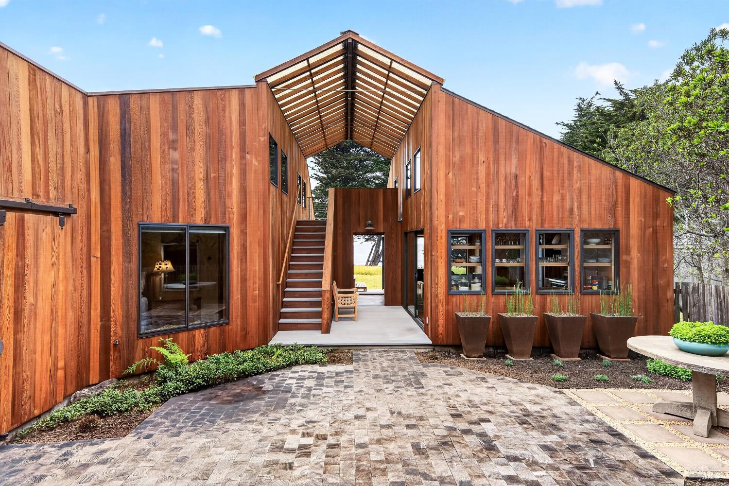 233 Solstice The Sea Ranch, CA 95497 - Photo 2 of 90 One-of-a-kind residence invites entry through a sheltered courtyard which draws one in deeper to reveal a connection to the interior spaces that join the coastal landscape. Pictured here: courtyard entry to main residence