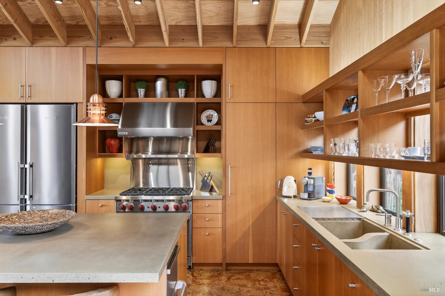 233 Solstice The Sea Ranch, CA 95497 - Photo 24 of 90 Kitchen with stained concrete floor, fir wood cabinetry/shelving and concrete counter/sink