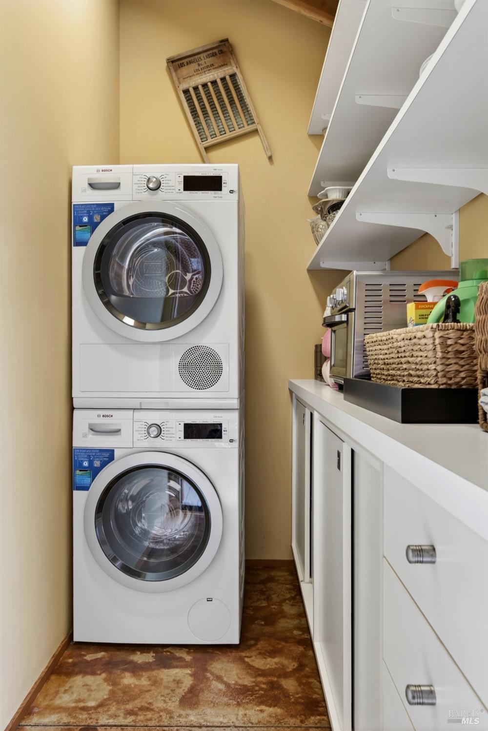233 Solstice The Sea Ranch, CA 95497 - Photo 51 of 90 Laundry room with stacked washer and dryer and storage
