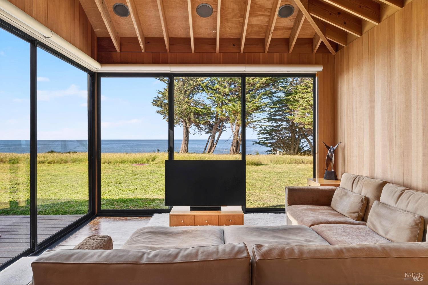 233 Solstice The Sea Ranch, CA 95497 - Photo 7 of 90 Wall of glass frames the Pacific Ocean for white water views in this stylish and refined living room