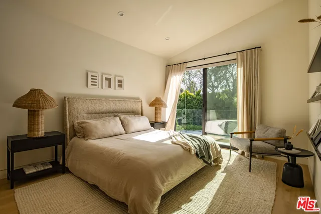 a bedroom with a bed and a night stand