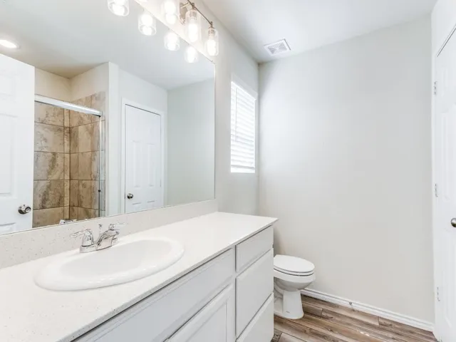 a bathroom with a sink a toilet and mirror