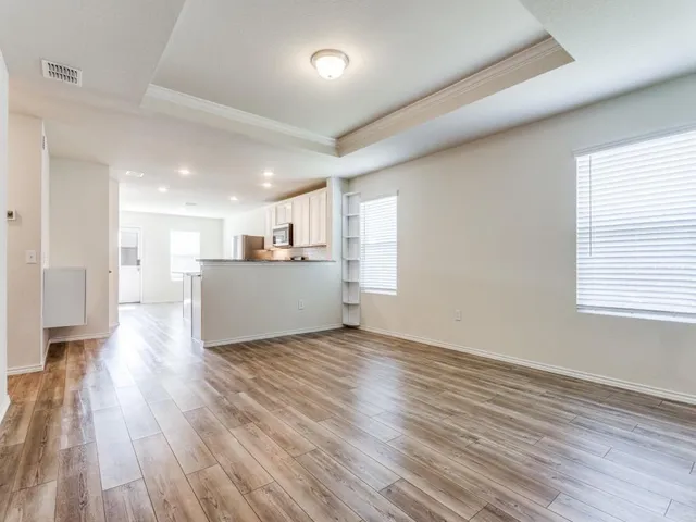 a view of a kitchen with wooden floor and a kitchen
