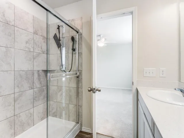 a bathroom with a shower and a sink