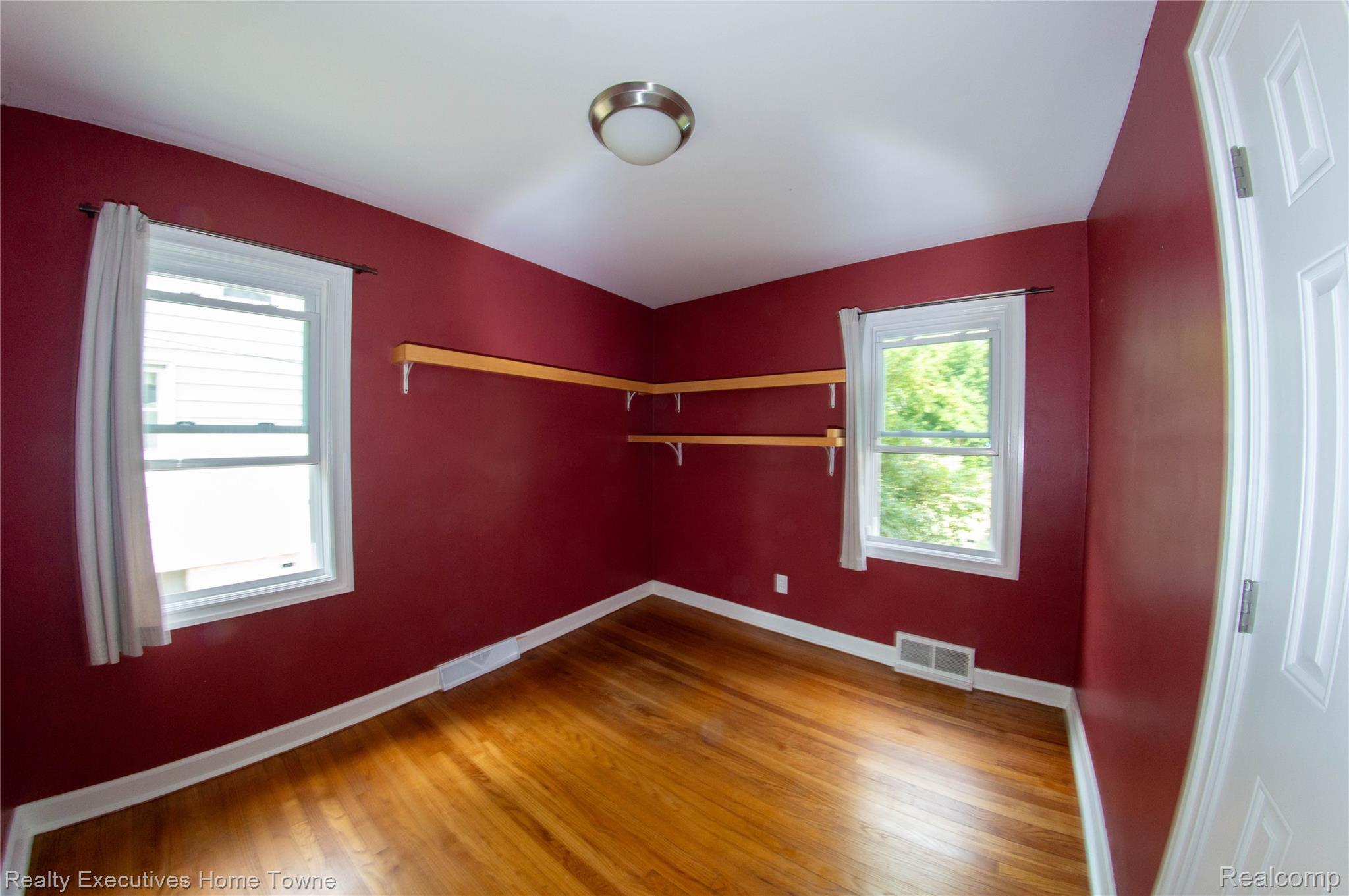 2676 Cumberland Road Berkley, MI 48072 - Photo 10 of 38 Room featuring wood-finish flooring, white baseboards, and two double-hung windows