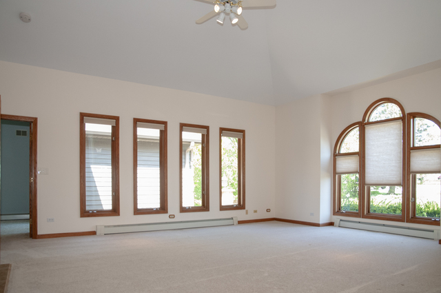 201 East Army Trail Road Bartlett, IL 60103 - Photo 19 of 59 an empty room with windows and ceiling fan