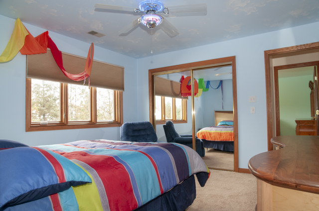 201 East Army Trail Road Bartlett, IL 60103 - Photo 40 of 59 a bedroom with a bed and a chandelier