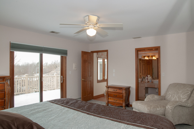 201 East Army Trail Road Bartlett, IL 60103 - Photo 44 of 59 a bedroom with a bed and wooden floor