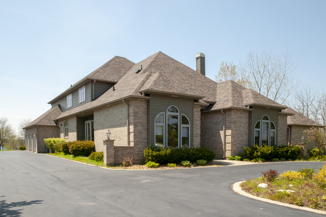 201 East Army Trail Road Bartlett, IL 60103 - Photo 6 of 59 a front view of a house with a yard and potted plants