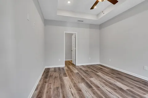 a view of a room with wooden floor