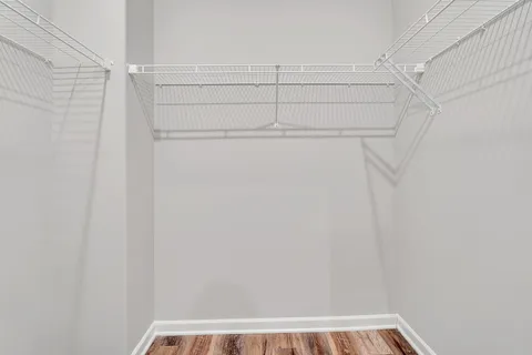 a view of walk in closet with empty racks