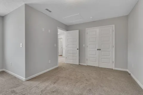 an empty room with closet area