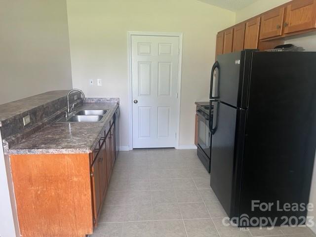 176 Oak Tree Road Mooresville, NC 28117 - Photo 3 of 14 a kitchen with a refrigerator and a sink