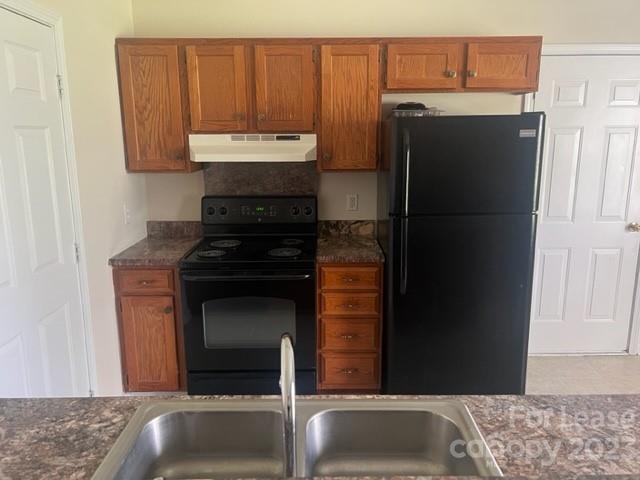 176 Oak Tree Road Mooresville, NC 28117 - Photo 5 of 14 a kitchen with a sink and a refrigerator