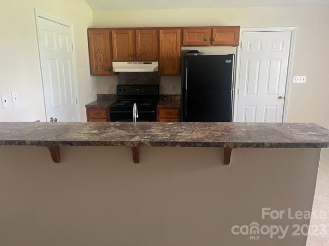 176 Oak Tree Road Mooresville, NC 28117 - Photo 6 of 14 a kitchen with a refrigerator and a sink