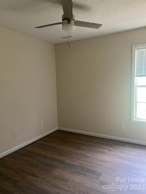 176 Oak Tree Road Mooresville, NC 28117 - Photo 8 of 14 a view of an empty room with wooden floor and a window