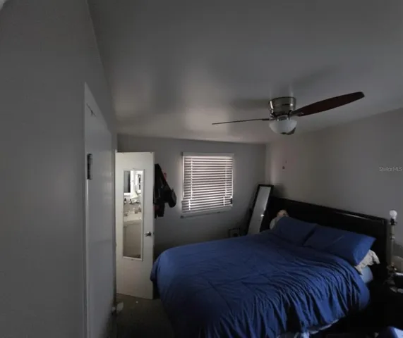 a bedroom with a bed and window