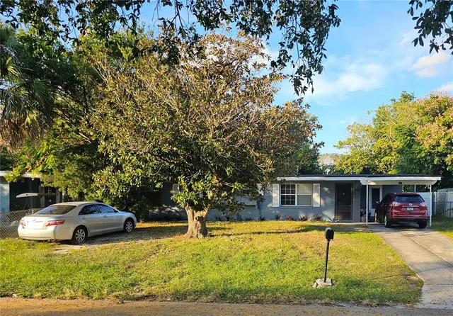 a view of a house with swimming pool and sitting area