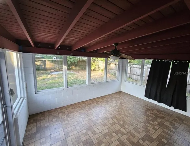 an empty room with windows and city view