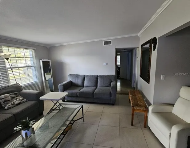 a living room with furniture and a window