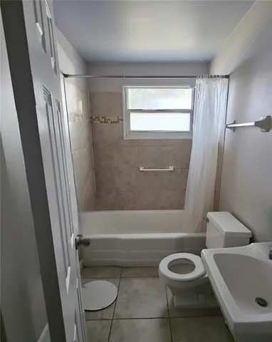 a bathroom with a toilet a sink and bathtub