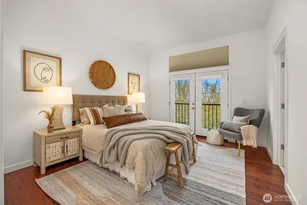 a bedroom with bed and a large window
