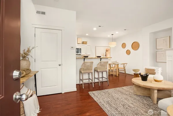a living room with furniture and wooden floor