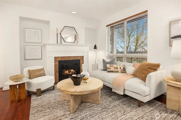 a living room with furniture a fireplace and a table