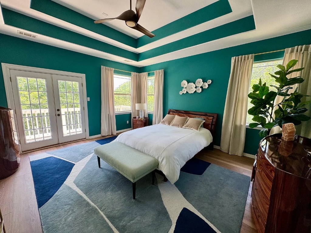 a bed sitting in a room next to a window