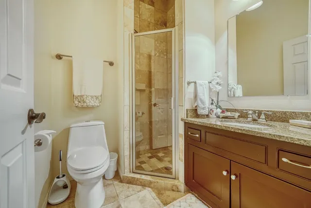a spacious bathroom with a granite countertop sink and a mirror