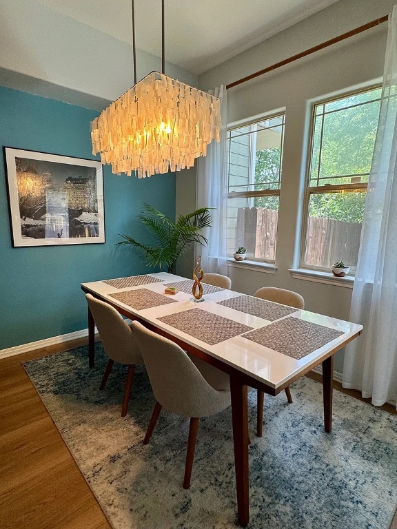 1009 Taulbee Lane, Unit H Austin, TX 78757 - Photo 3 of 17 a table and chairs in a room with a window