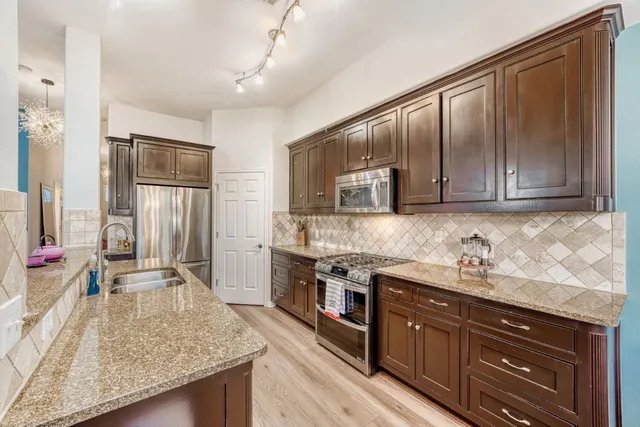 a kitchen with a stove and a sink